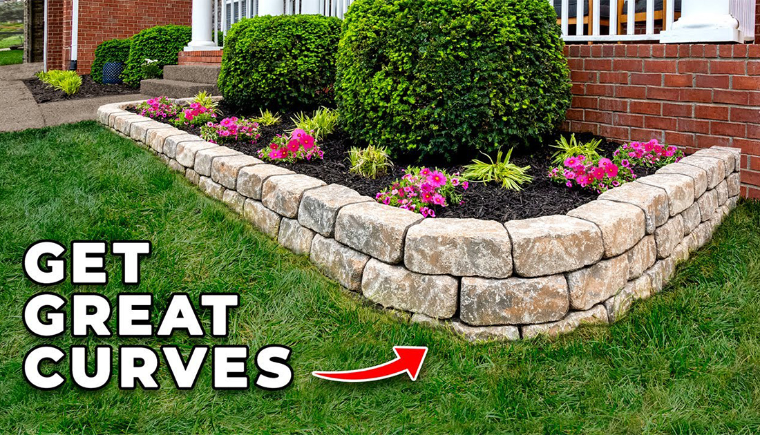 A landscaped garden with a curved stone wall, vibrant pink flowers, green bushes, and a manicured lawn in front of a brick home. Text on image reads "get great curves.
